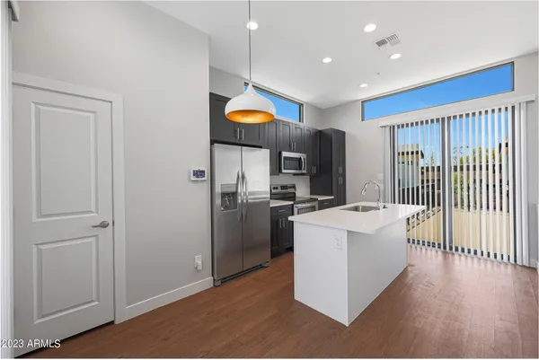 a kitchen with stainless steel appliances a refrigerator and a stove top oven