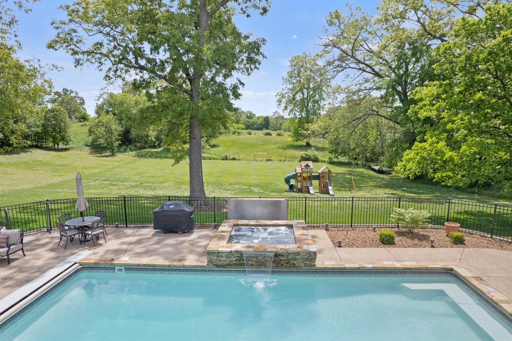 264 Cascade Drive Winchester, TN 37398 - Photo 4 of 86 a view of a lake with a yard and a fountain
