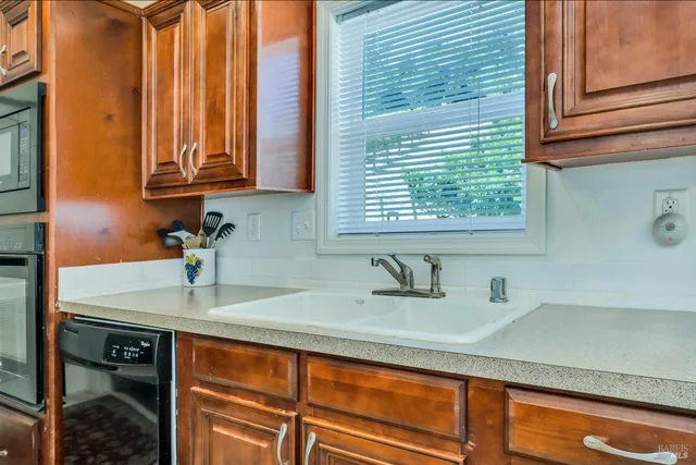 a kitchen with a sink cabinets and a window