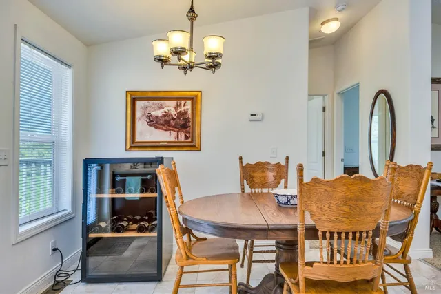 a view of a dining room with furniture and chandelier
