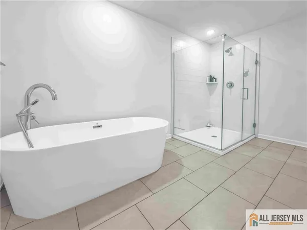 a bathroom with a bathtub and shower