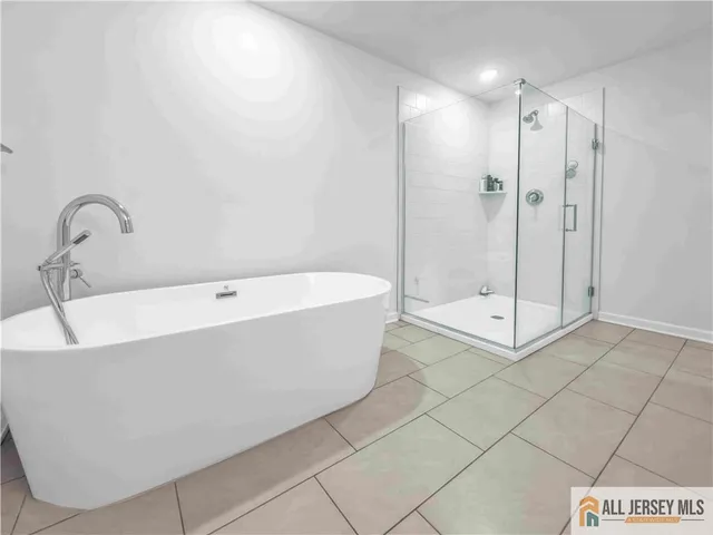 a bathroom with a bathtub and shower