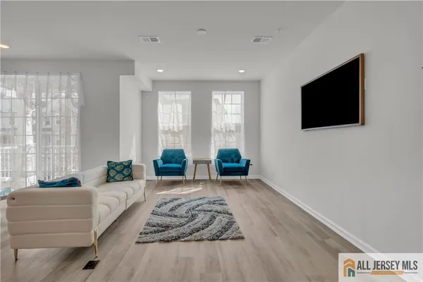 a spacious bedroom with a large bed and a flat screen tv