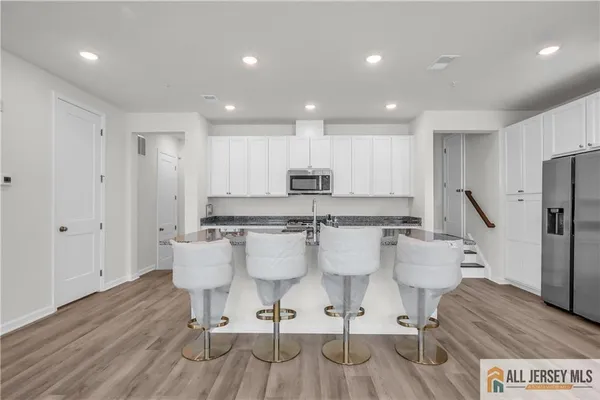 a large kitchen with a table and chairs