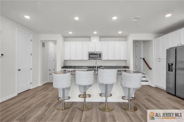 a large kitchen with a table and chairs