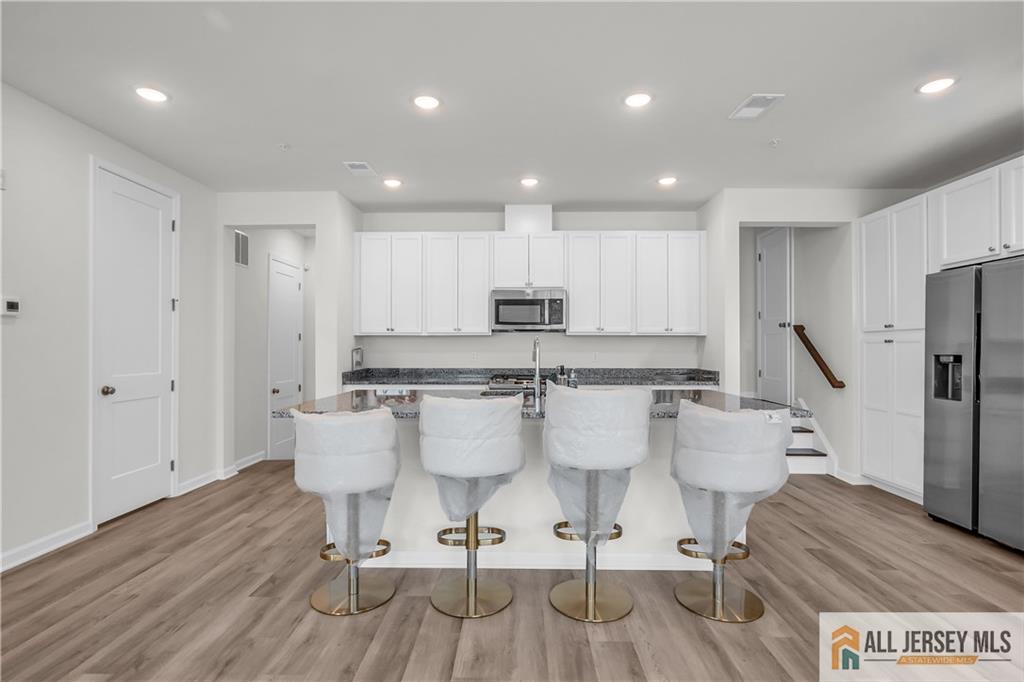 204 Honeysuckle Lane Warren, NJ 07059 - Photo 7 of 17 a large kitchen with a table and chairs