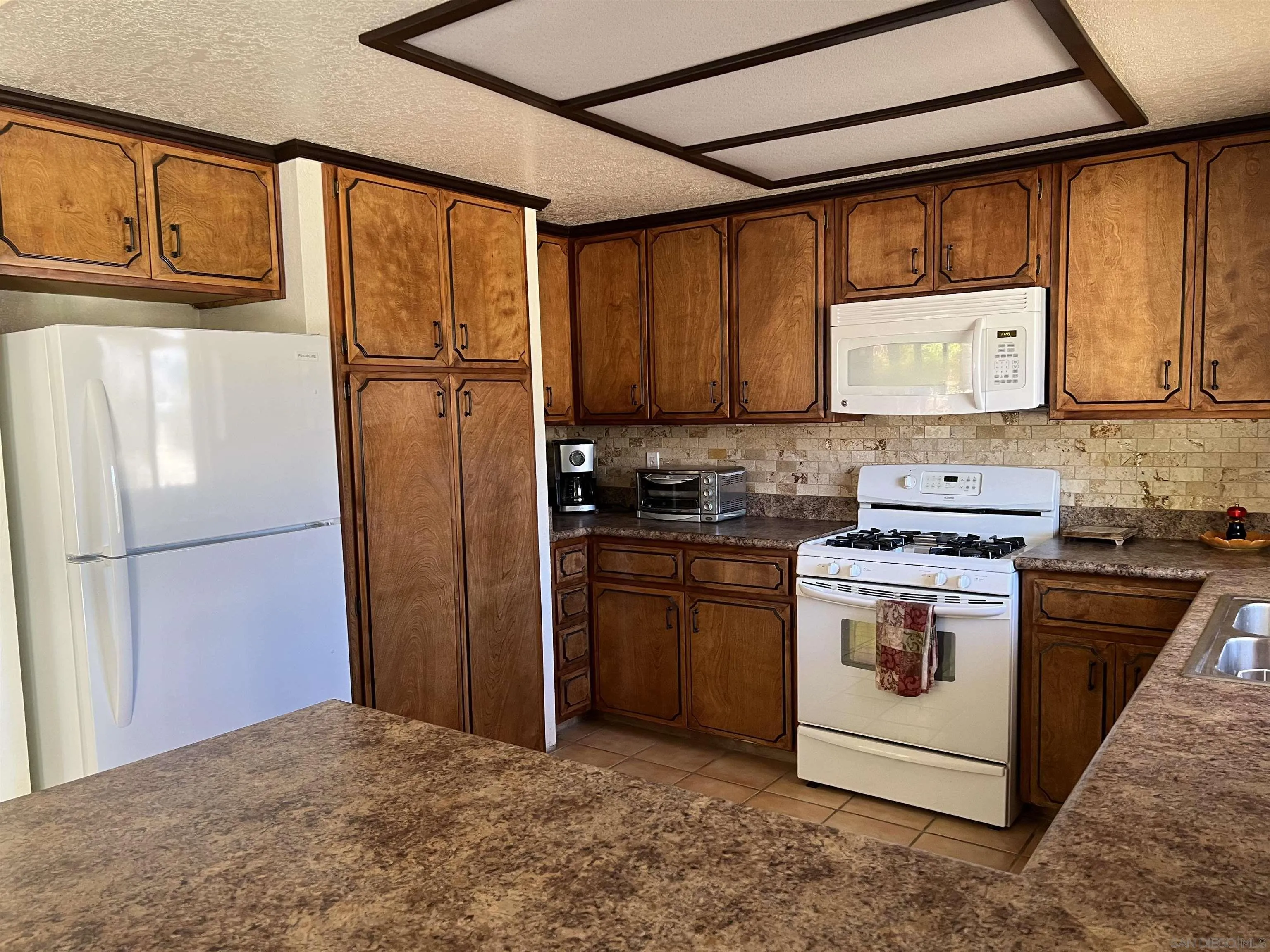 2960 Frying Pan Road Borrego Springs, CA 92004 - Photo 10 of 28 a kitchen with a refrigerator sink and stove