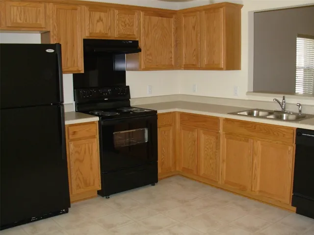 a kitchen with a sink and a refrigerator