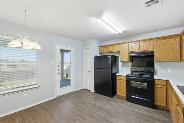 a kitchen with stainless steel appliances granite countertop a refrigerator and a stove