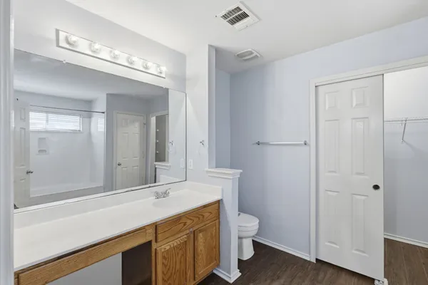 a bathroom with a sink a toilet and a mirror