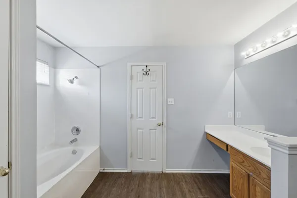 a bathroom with a bathtub and a shower
