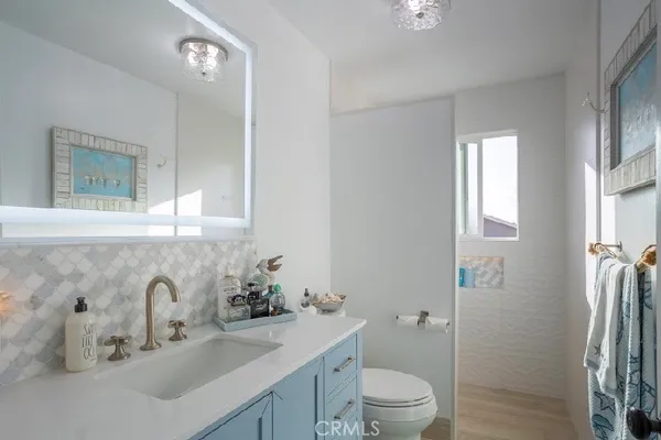 a bathroom with a granite countertop sink toilet and shower