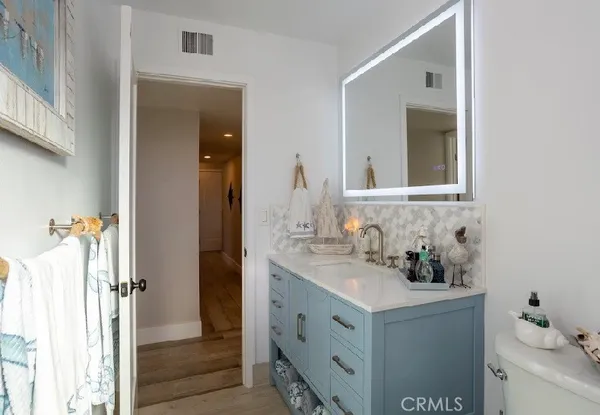 a bathroom with a sink vanity and a mirror