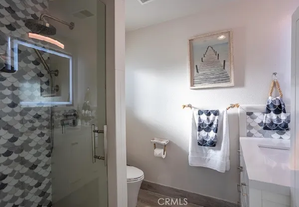 a bathroom with a toilet sink and shower