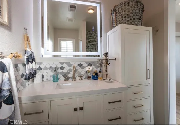 a bathroom with a sink a mirror and a window