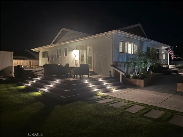 a front view of a house with a garden and patio