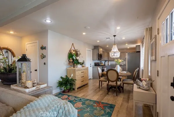 a living room with furniture and a dining table with kitchen view