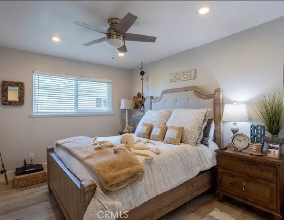 a bedroom with bed cabinet and window