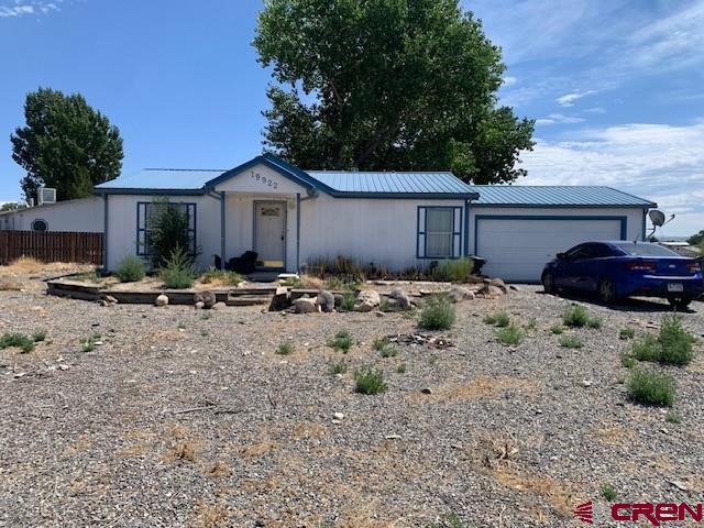 a view of backyard of house with outdoor seating and green space