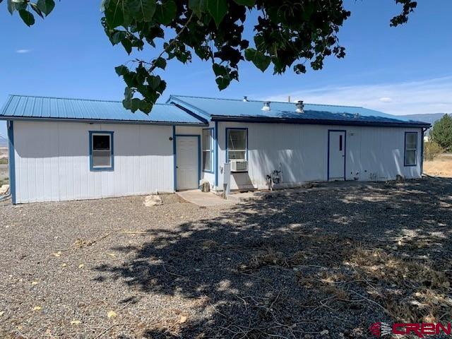 19922 Jay Road Austin, CO 81410 - Photo 2 of 14 a front view of a house with a yard