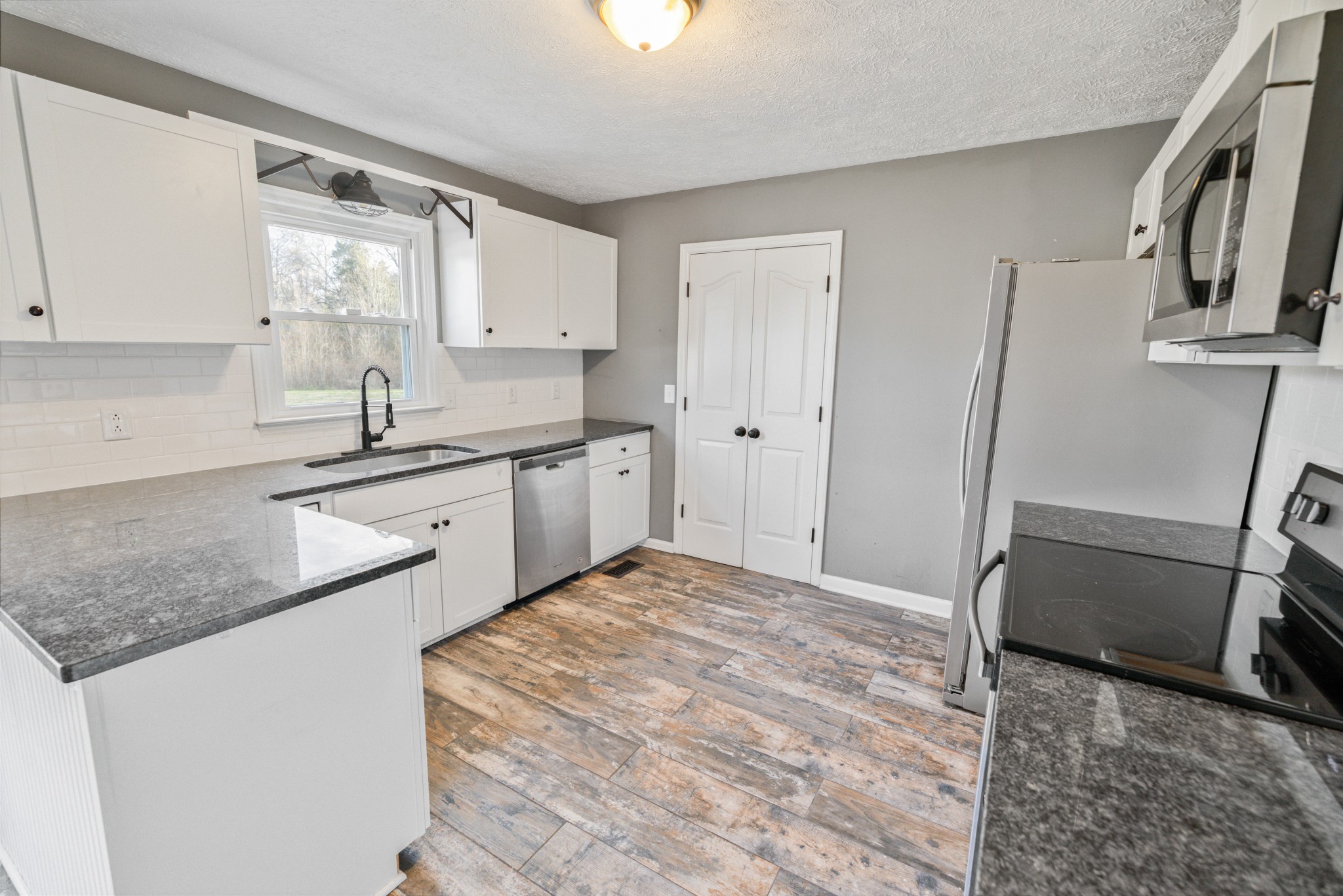 109 Lafayette Rockvale, TN 37153 - Photo 12 of 43 a kitchen with stainless steel appliances granite countertop a sink stove and refrigerator