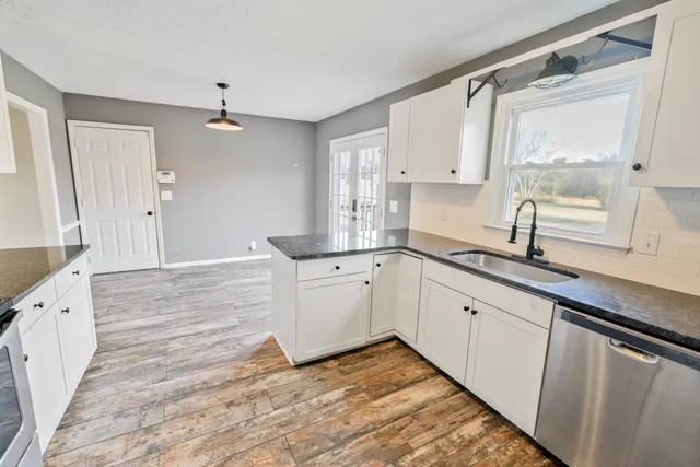 a kitchen with white cabinets and white appliances