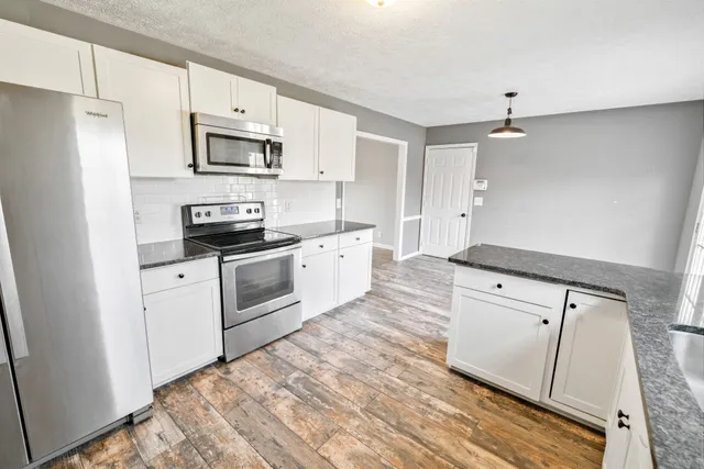 a view of a chandelier fan in a room