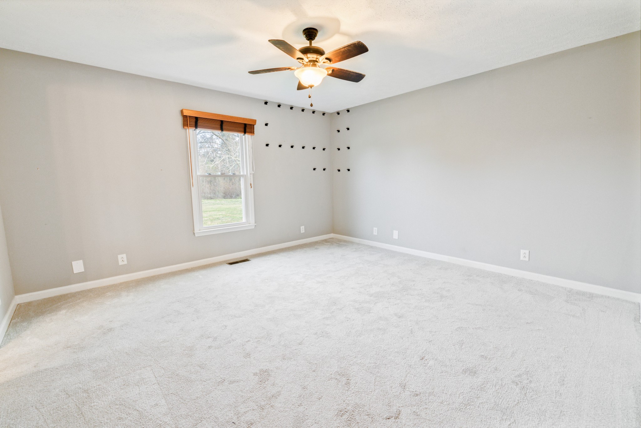 109 Lafayette Rockvale, TN 37153 - Photo 16 of 43 an empty room with a chandelier fan and windows