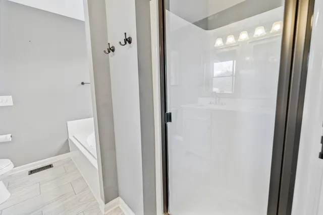 a bathroom with a tub and a window