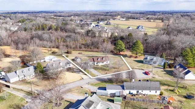 a view of a backyard with table and chairs