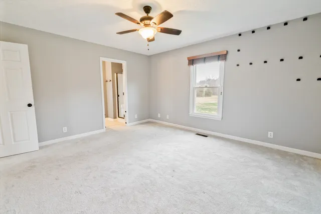 a view of a room with gym equipment and a fireplace