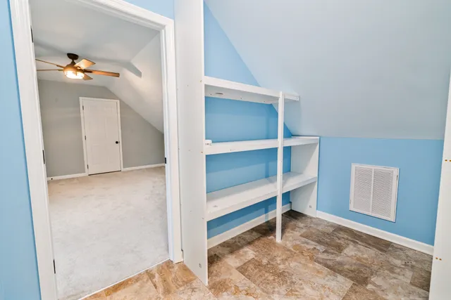 a bathroom with a toilet sink vanity and tub