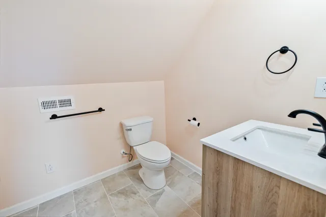 a view of a livingroom with a ceiling fan and staircase