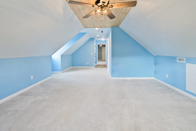 a view of an empty room with a ceiling fan