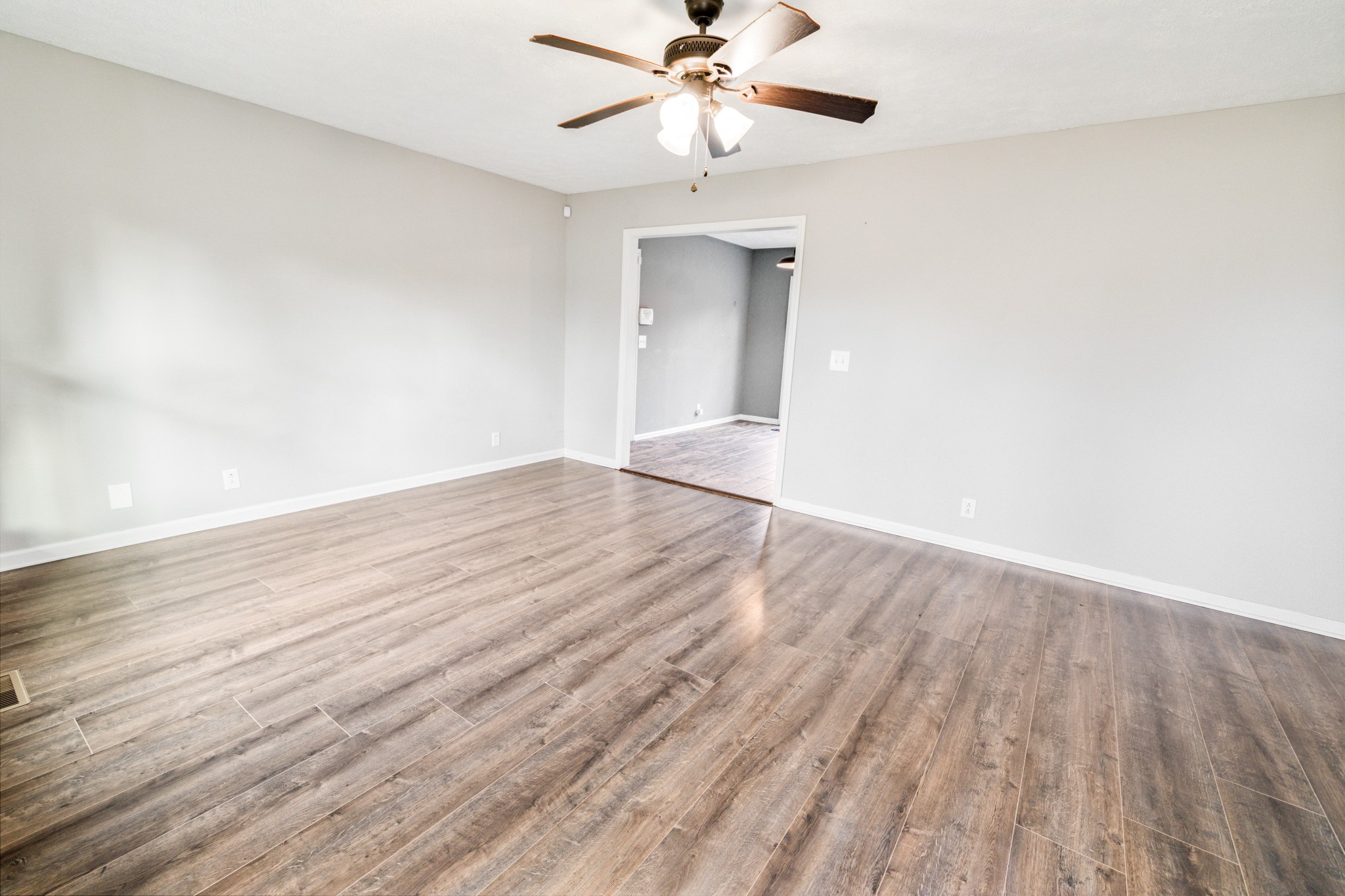 109 Lafayette Rockvale, TN 37153 - Photo 8 of 43 a view of an empty room with wooden floor and a ceiling fan