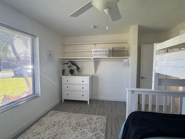 a spacious bedroom with a bed and a dresser
