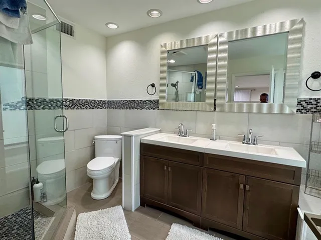 a bathroom with a sink toilet and shower