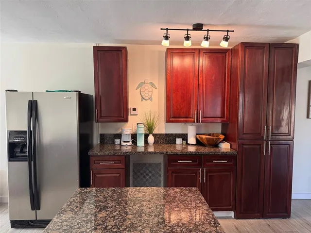 a kitchen with a refrigerator and cabinets