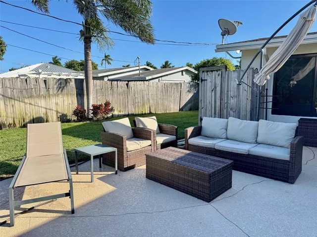 a living room with furniture and a view of wooden floor