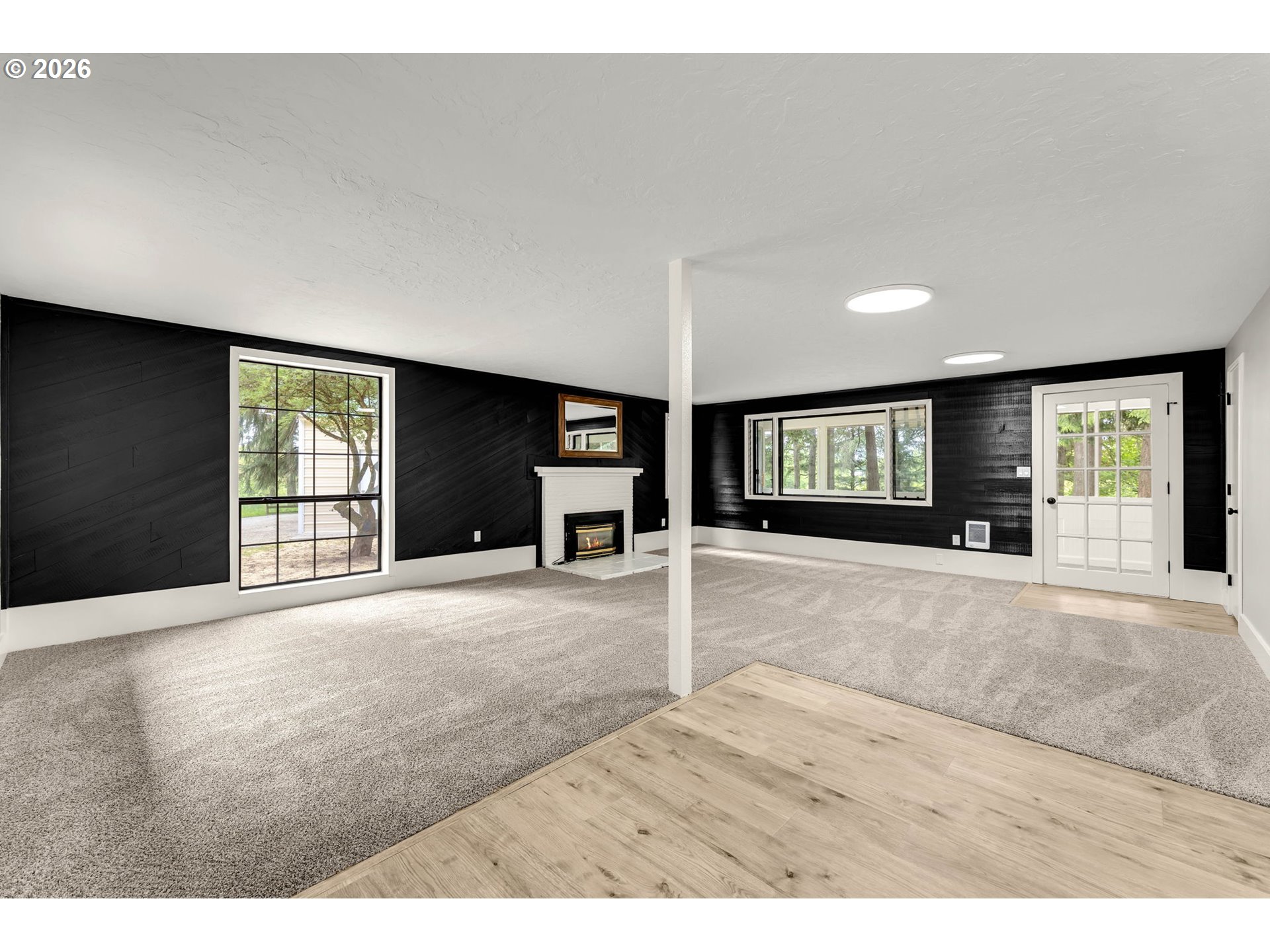 30921 Northwest Spencer Road La Center, WA 98642 - Photo 4 of 39 a view of an empty room with window and wooden floor