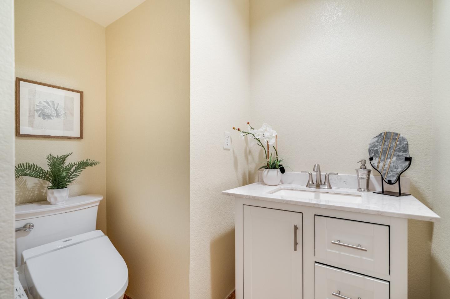 6936 Gregorich Drive, Unit E San Jose, CA 95138 - Photo 12 of 44 a bathroom with a toilet sink and vanity