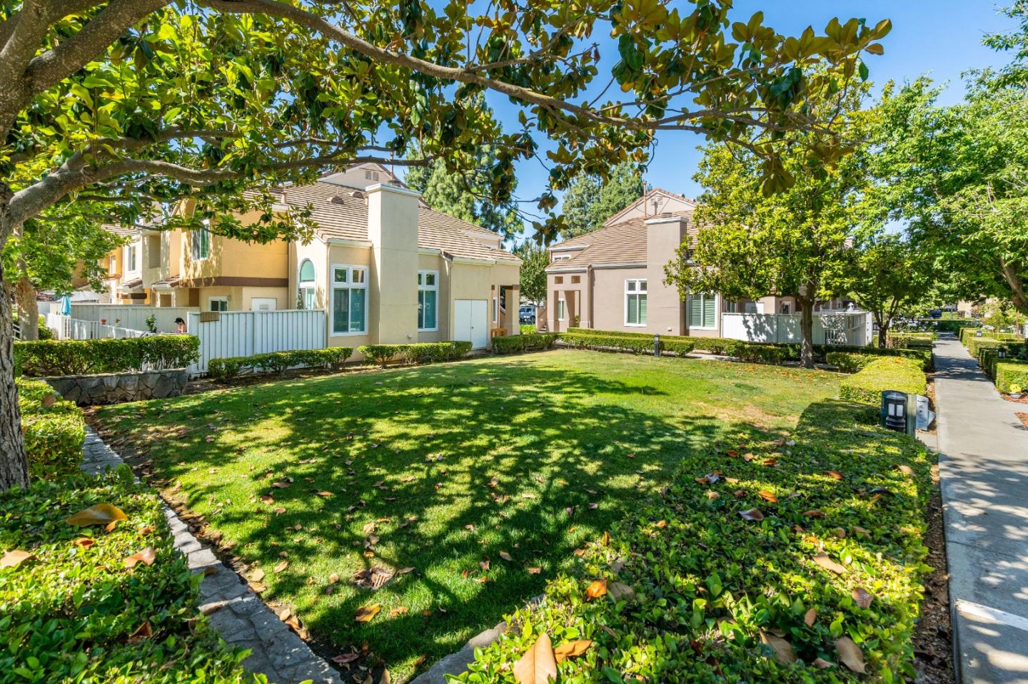 6936 Gregorich Drive, Unit E San Jose, CA 95138 - Photo 37 of 44 a front view of a house with a garden