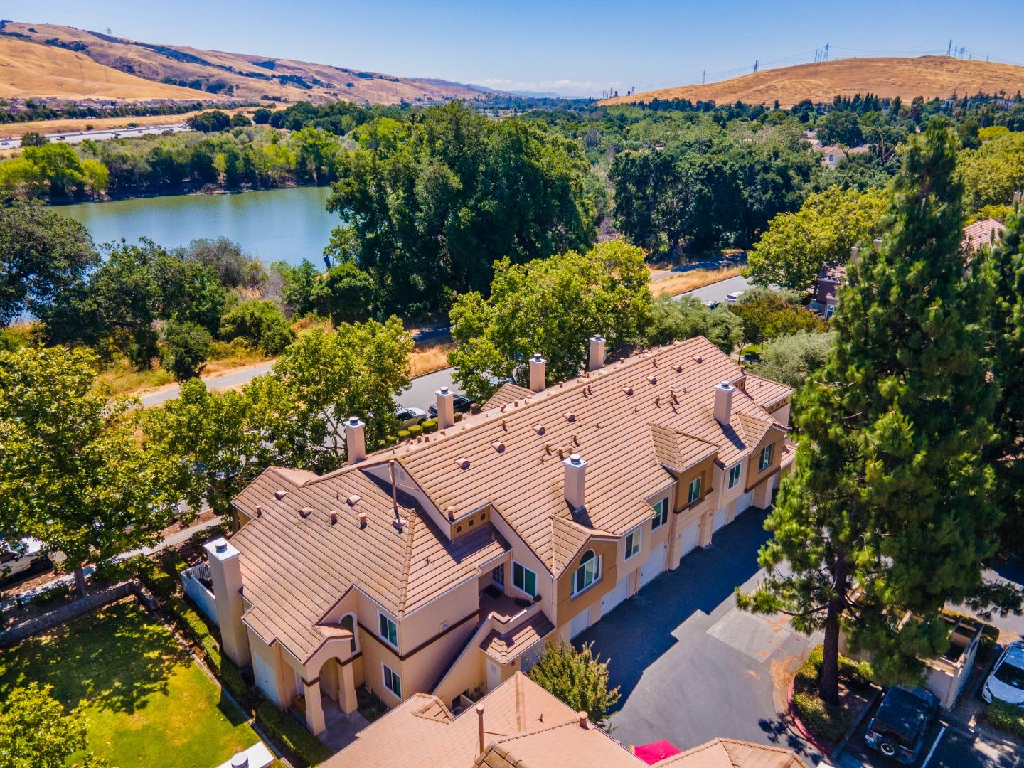 6936 Gregorich Drive, Unit E San Jose, CA 95138 - Photo 39 of 44 an aerial view of a house with a garden and lake view