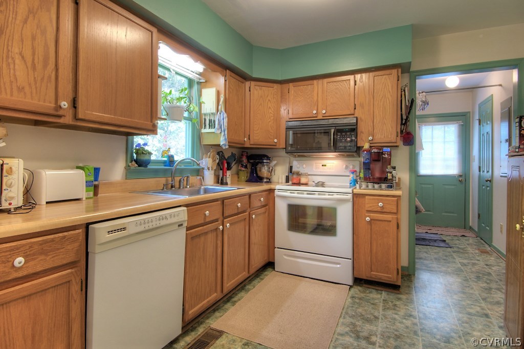 17516 Old Ridge Road Montpelier, VA 23192 - Photo 11 of 27 a kitchen with stainless steel appliances granite countertop a stove a sink and a microwave