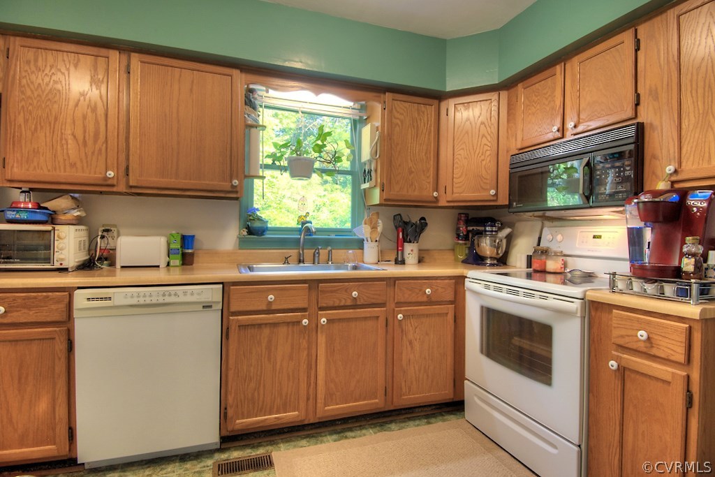 17516 Old Ridge Road Montpelier, VA 23192 - Photo 12 of 27 a kitchen with cabinets appliances a sink and a window