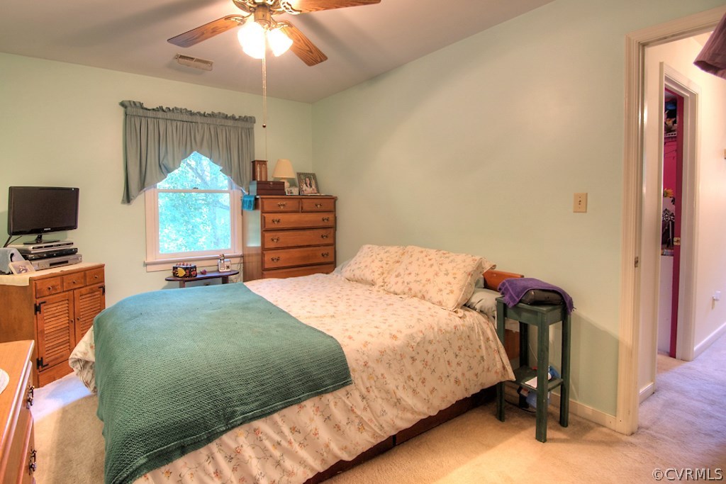 17516 Old Ridge Road Montpelier, VA 23192 - Photo 17 of 27 a bedroom with a bed and a chandelier