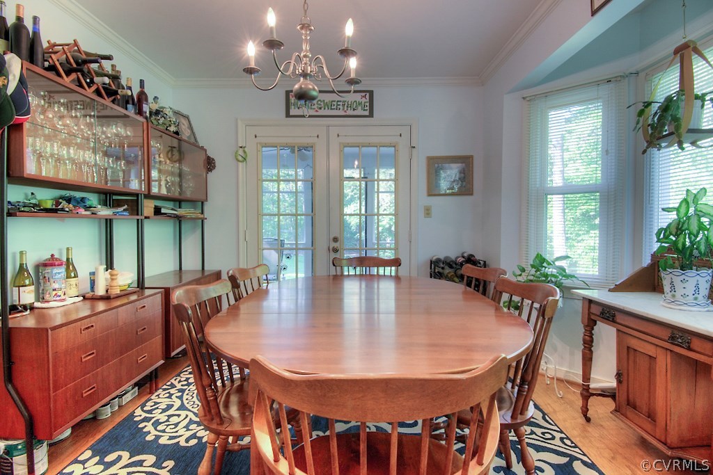 17516 Old Ridge Road Montpelier, VA 23192 - Photo 10 of 27 a dining room with wooden floor a chandelier a wooden table and chairs