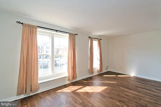 a kitchen with stainless steel appliances granite countertop a refrigerator a sink dishwasher a stove with wooden floor and cabinets