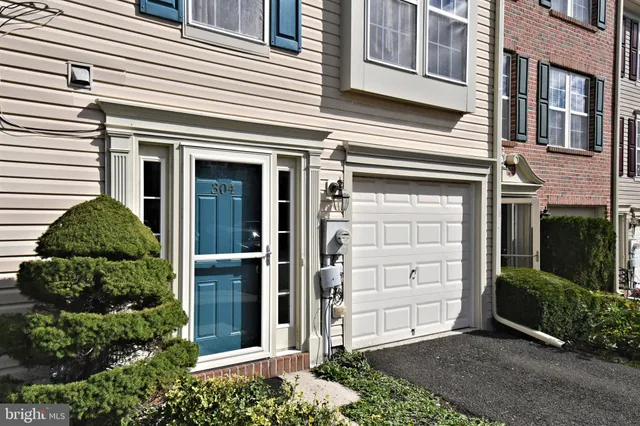 front view of a house with a window and a yard