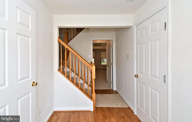 a view of a hallway with wooden floor and entryway